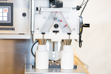 Pharmafill TC4 tabletop tablet counter closeup of two bottles