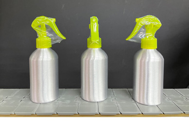 Spray bottles with tamper-evident neck bands by Deitz Pharmafill NB1 neck bander