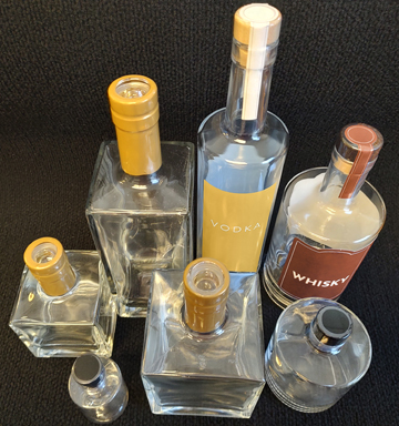 Long neck wine and liquor bottles tamper-evident banded on Pharmafill NB1 neck banding machine