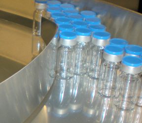 Powered Turntables Feed Glass Containers Into Filling Line Gently, Automatically