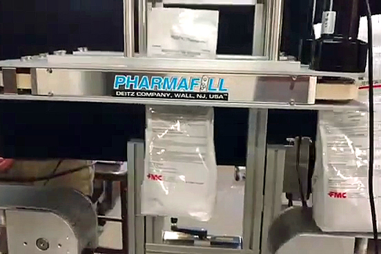 Pharmafill BCV1 bottomless conveyor holds fleixble packaging bag for printing on bottom automatically